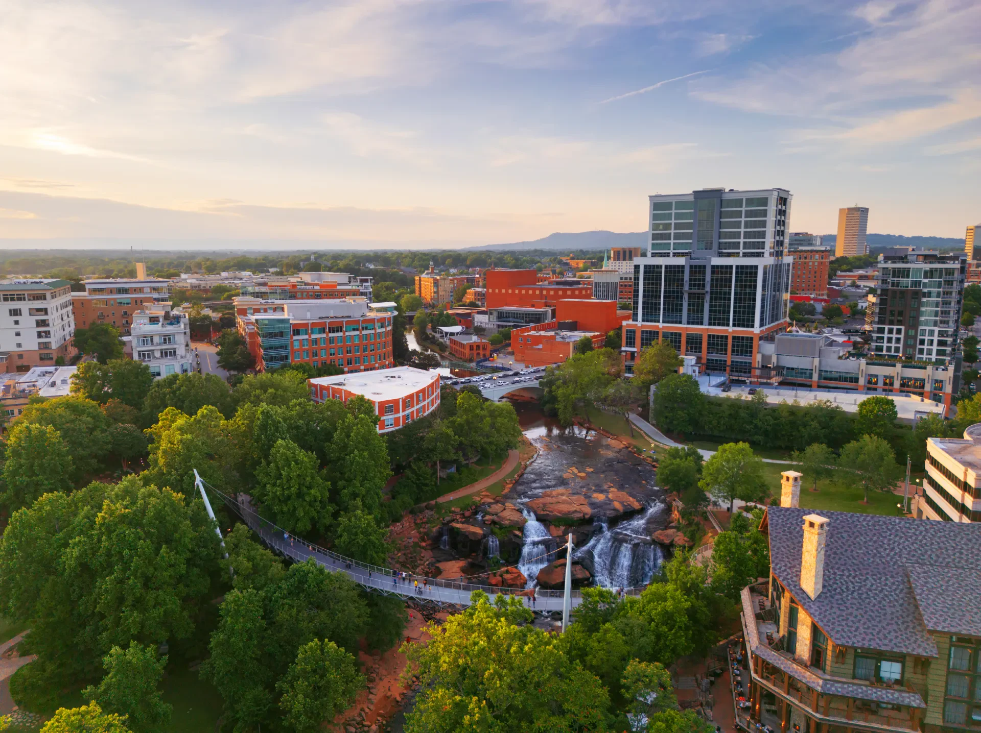 Aerial view of Liberty Bridge and waterfalls in Falls Park, downtown Greenville.